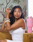 Sip, Sparkle & Slay Set featuring a pink crystal sparkle tumbler, light brown brow pencil, Noemi Mirage shimmering bangle, and Jumanji Untamed Beauty ivory statement bangle.