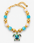 Chunky coastal statement necklace featuring oversized beads and a blue and green enamel sea turtle pendant.