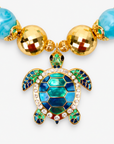 Chunky coastal statement necklace featuring oversized beads and a blue and green enamel sea turtle pendant.