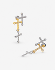 Trinity 18K Cross Sparkling Earrings featuring three cascading crystal crosses in gold and silver finishes. Woman wearing Trinity statement earrings with layered gold and silver crystal cross motifs. Sassy Jones Trinity drop earrings featuring three sparkling crosses in contrasting mixed metal finishes. Close up of crystal cross earrings with a silver cross stud, gold center cross and dangling silver cross. Trinity faith inspired earrings featuring cascading crystal embellished crosses in gold and s