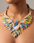 Oversized Victoriana statement necklace featuring an intricately detailed peacock with colorful sculptural plumage.