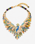 Victoriana Prissy Peacock Necklace featuring a blue peacock surrounded by layered multicolor enamel feathers.