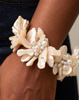 Wisteria Mother of Pearl statement bracelet featuring layered shell flowers in creamy ivory and champagne tones.