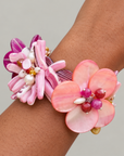 Wisteria Pink and Orange Abalone Bracelet featuring sculptural flowers crafted from laser cut mollusk shell in vibrant sunset colors.