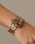 Sassy Jones Zahara Adjustable Cuff featuring an oversized brown centerpiece surrounded by sparkling crystals and golden accents.
