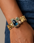 Sassy Jones Zahara Green cuff featuring an oversized jewel toned centerpiece with dimensional stone accents.