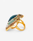 Green statement ring featuring an oversized jewel toned stone surrounded by sparkling crystals and sage green accents.