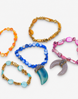 Five piece Zuma bracelet stack featuring orange, pink, blue, turquoise, and gold beads with sparkling shell pendants.