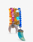Zuma multicolor bracelet stack featuring vibrant hand strung beads and blue and natural shell pendants with sparkling accents.
Close-up of Zuma five piece bracelet stack with colorful shell beads, golden hematite, chalcedony, and sculptural dangling charms.