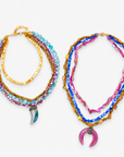 Colorful statement necklace featuring cascading pink, blue, turquoise, purple, and gold shell bead strands.