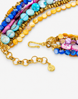 Colorful layered shell necklace featuring vibrant bead strands and a detachable pink crescent charm.
Zuma multicolor statement necklace featuring cascading shell beads, dimensional crystal detailing, and sculptural crescent pendant.