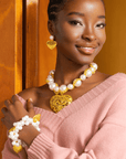 Full Amora jewelry set including necklace, earrings, and bracelet in ivory and gold.