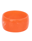 Chunky coral orange resin bangle bracelet with glossy translucent marbling on a white background.