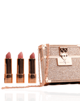 Luxury pink lipstick travel set featuring three velvety matte pink lipsticks in a glittering rose gold keepsake case with chain strap