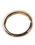 Glossy champagne gold resin bangle bracelet with smooth rounded silhouette on a white background.