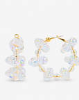 Iridescent statement hoop earrings featuring dimensional clear bubble beads and delicate gold details.