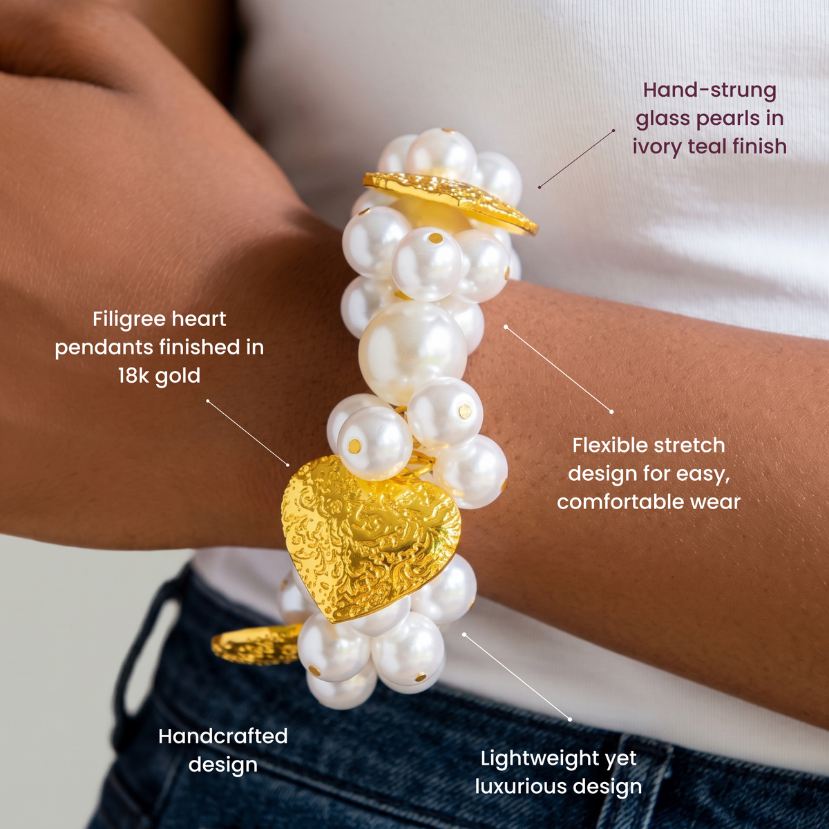 Ivory pearl stretch bracelet featuring dimensional pearl clusters and sculpted hearts with Gold tone finish.