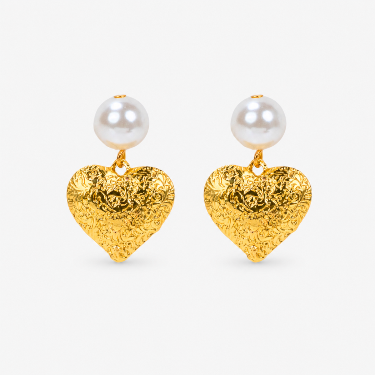 Amora Pearl Heart Dangles in Ivory and Gold featuring oversized pearl tops and embossed gold heart pendants.