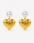 Amora Pearl Heart Dangles in Ivory and Gold featuring oversized pearl tops and embossed gold heart pendants.