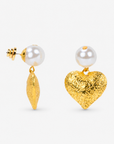 Close-up of Amora Pearl Heart Dangle on ear, gold and ivory details.      Sassy Jones Amora earrings featuring luminous pearl studs and dimensional heart shaped drops with ornate detailing.
