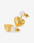 On model view of Amora Pearl Heart Dangle Earring featuring a luminous ivory pearl and sculptural gold heart.