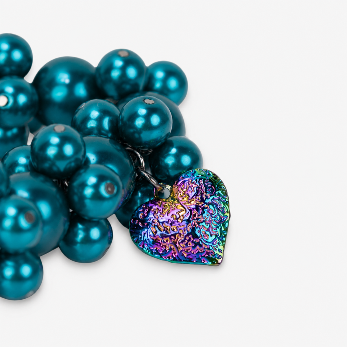 Chunky teal pearl statement bracelet featuring multicolor iridescent hearts in pink, green, blue and gold tones.