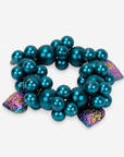 Amora Pearl Heart Stretch Bracelet featuring clustered teal glass pearls and iridescent rainbow heart charms.