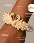 Ornate gold tone swan bracelet embellished with pavé crystals, ivory pearls, and an elegant double swan centerpiece.
