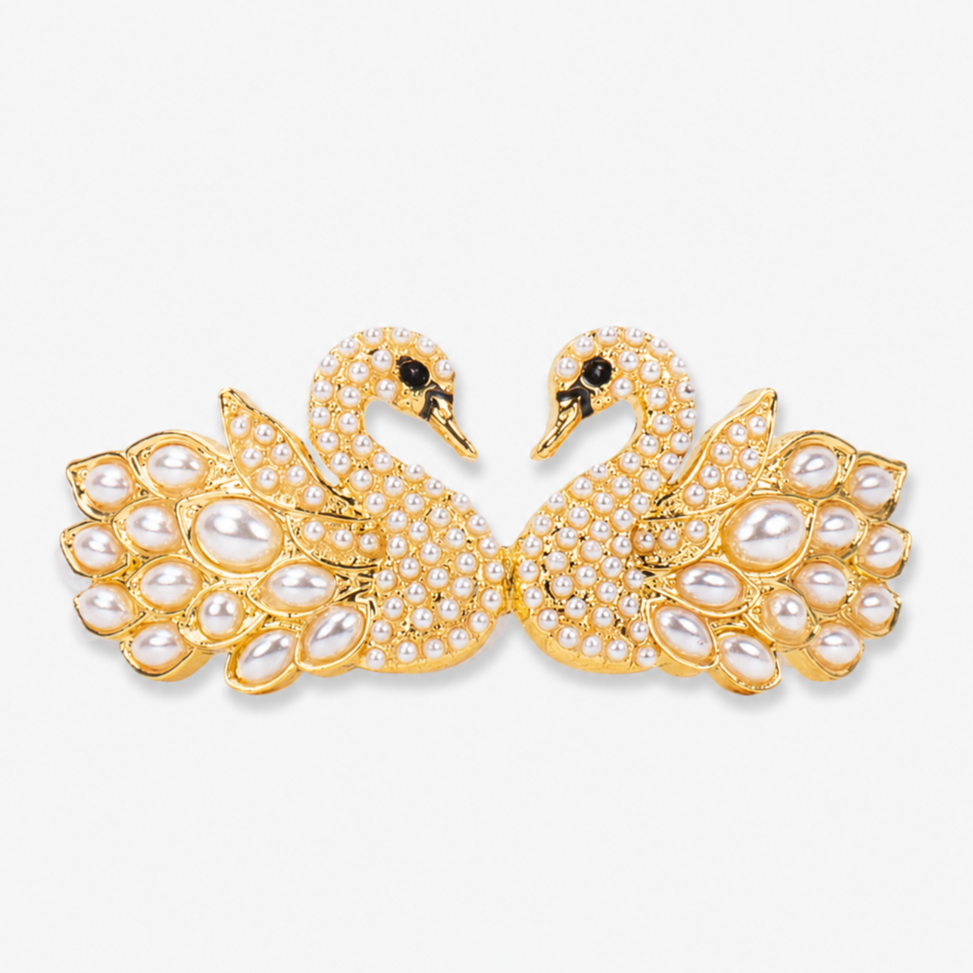 Anastasia statement bracelet featuring graceful gold swans, shimmering crystal details, sculptural pearl wings, and glossy pearl beads.