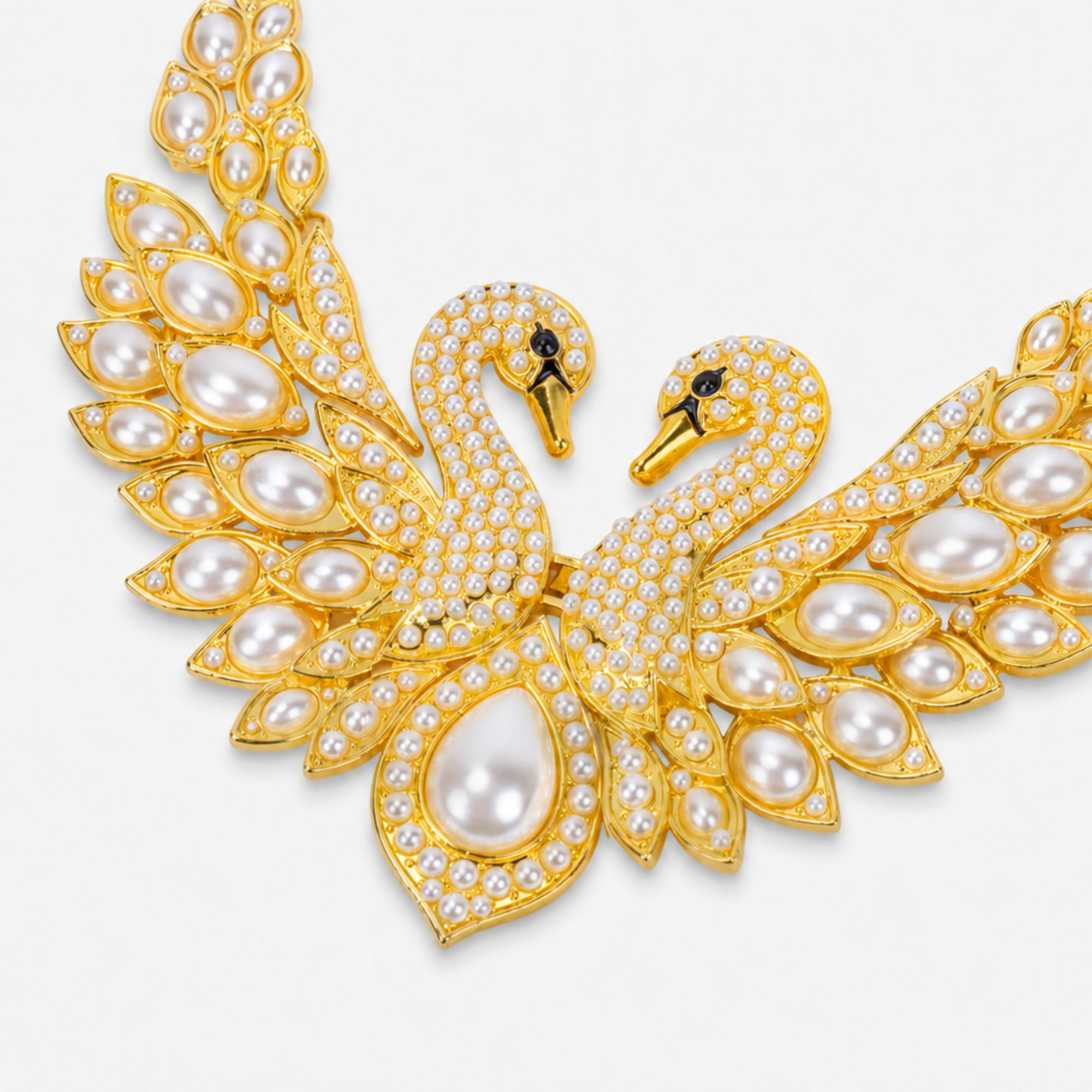 Anastasia statement necklace designed with two graceful swans, shimmering crystal accents, sculptural wings, and luminous ivory pearls.