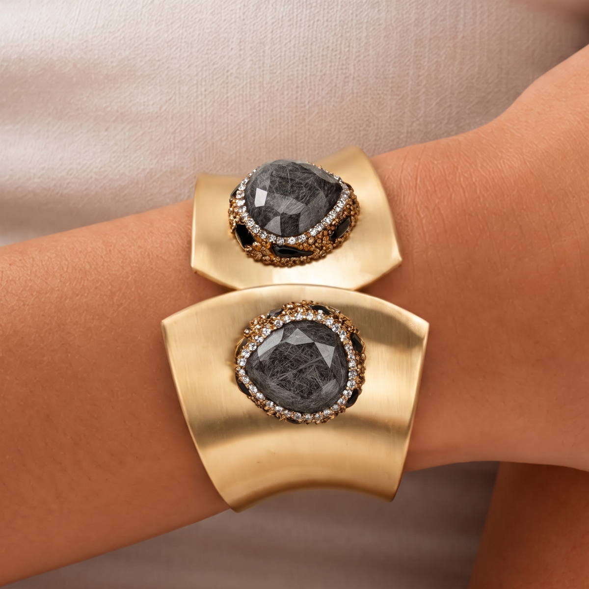 Sassy Jones Armana black statement cuff with organic stone centerpiece, crystal border and wide gold silhouette.