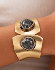Sassy Jones Armana black statement cuff with organic stone centerpiece, crystal border and wide gold silhouette.
