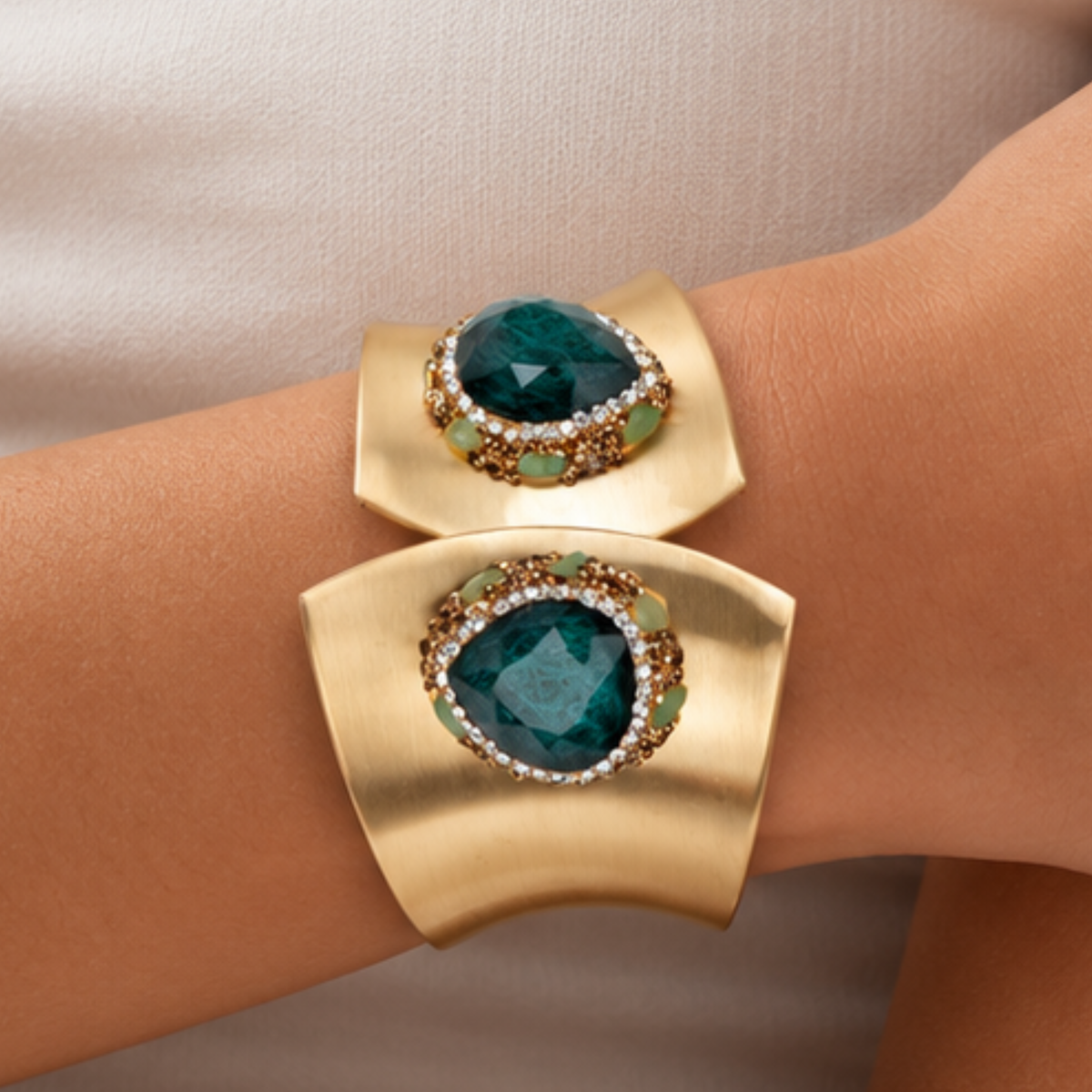 Sassy Jones Armana Emerald statement cuff featuring green stone details, crystal borders and textured gold accents.