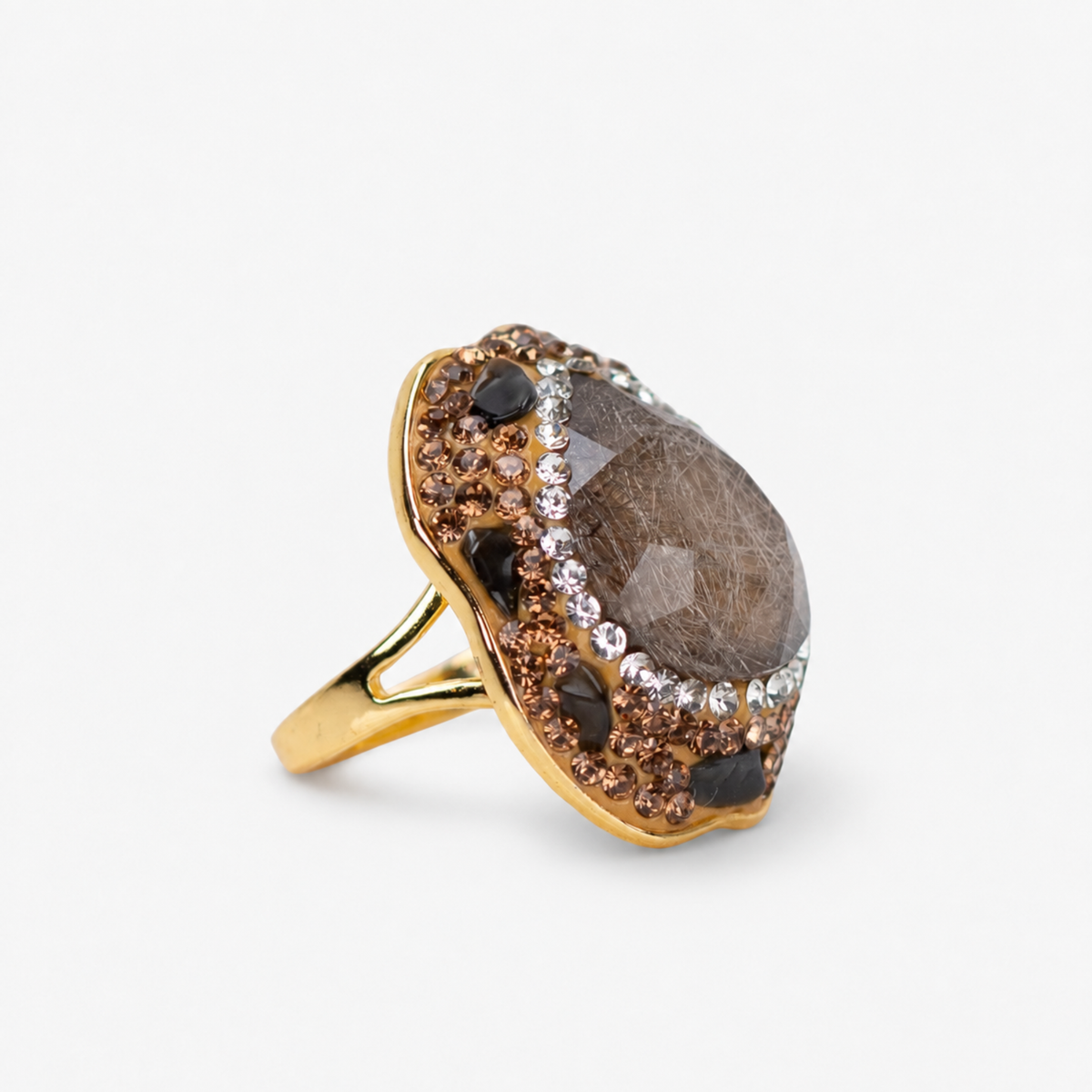 Black statement ring featuring a dark stone centerpiece surrounded by sparkling crystals and Gold tone finish.