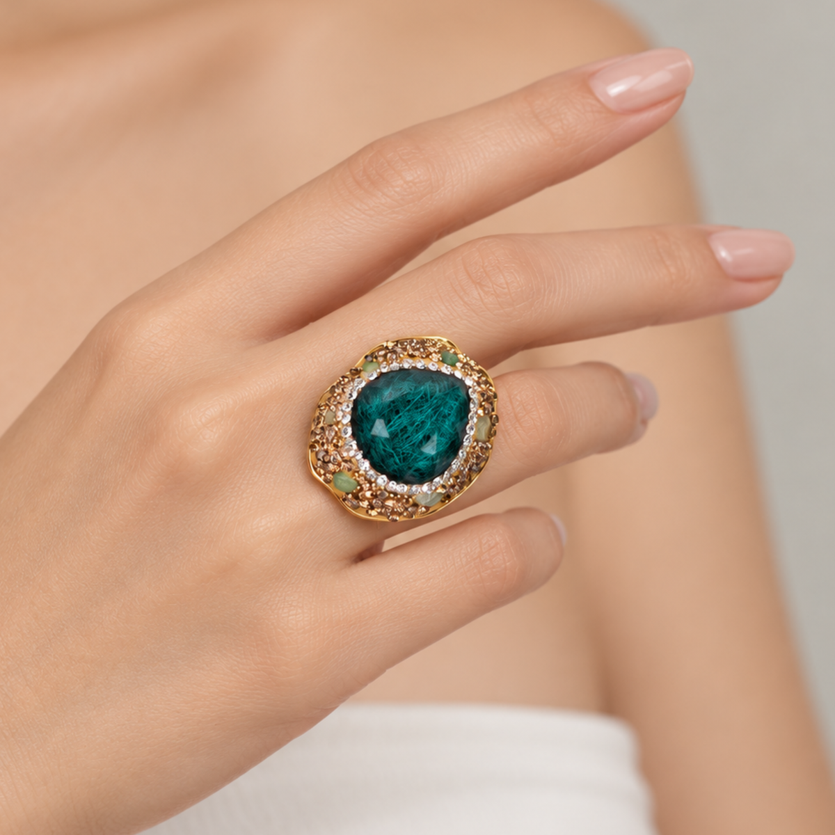 Sassy Jones Armana Emerald ring with a rich green stone centerpiece and dimensional embellished setting.