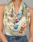 Close up of Auntie Pat Vintage Bow Scarf showcasing intricate floral china designs, gold detailing and pastel ribbon illustrations.