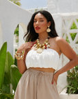Statement charm bracelet featuring coral accents, starfish charms, seashell details, pearl embellishments, pavé crystal accents, and gold-tone hardware by Sassy Jones.