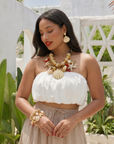 Gold shell dangle earrings featuring luminous pearl embellishments and coastal-inspired detailing by Sassy Jones.