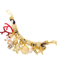 Statement charm bracelet featuring coral accents, starfish charms, seashell details, pearl embellishments, pavé crystal accents, and gold-tone hardware by Sassy Jones.