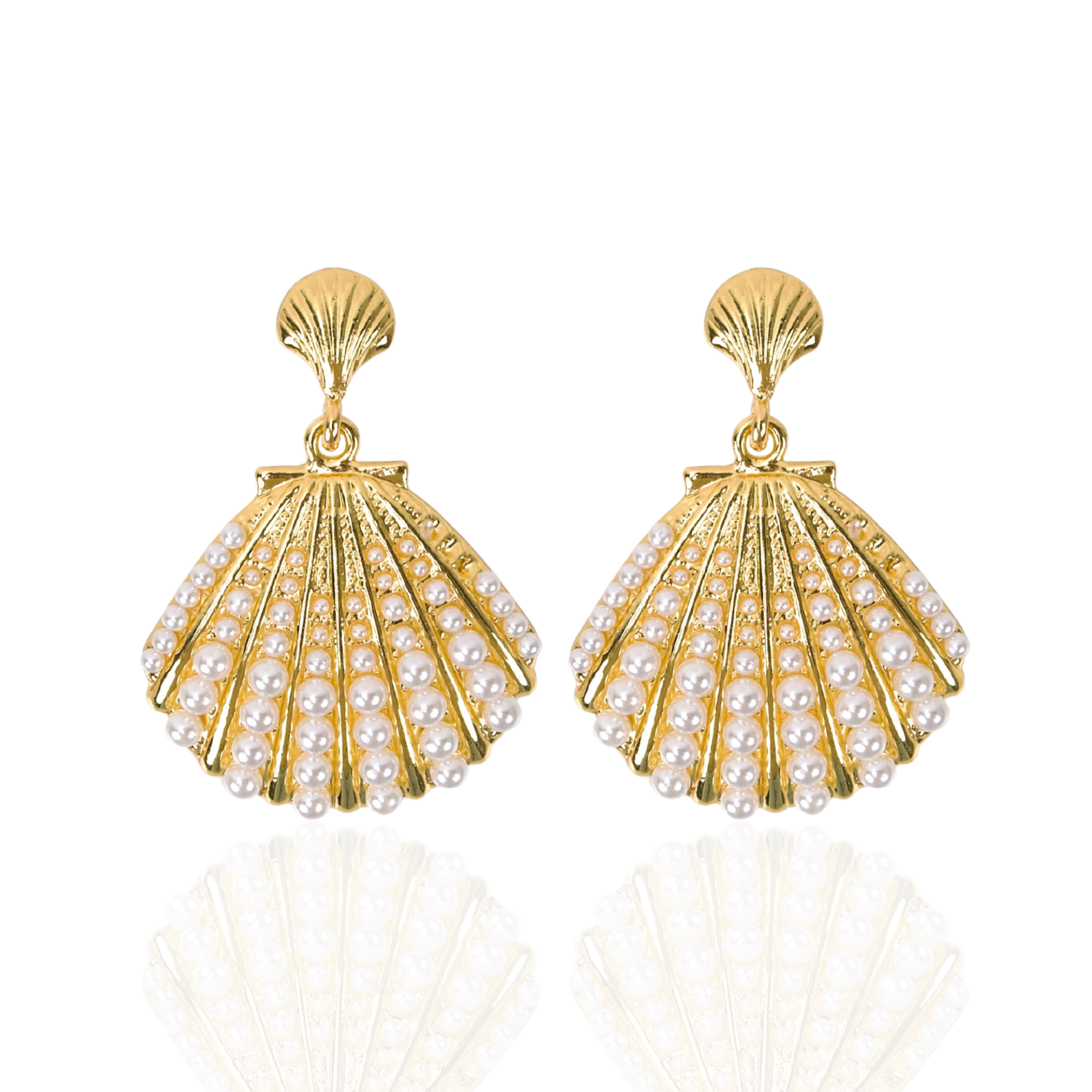 Gold shell dangle earrings featuring luminous pearl embellishments and coastal-inspired detailing by Sassy Jones.