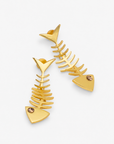 Caicos 18K Fishbone Dangle Earrings featuring sculptural gold plated fish skeleton silhouettes with crystal eye accents.