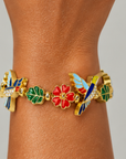 Nature inspired statement bracelet featuring dimensional hummingbirds, botanical leaves and vibrant floral embellishments.