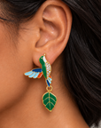 Close up of Cherish Hummingbird Earrings showcasing intricate blue wing detailing, green enamel and sparkling crystal embellishments.