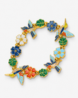 Sassy Jones Cherish Garden Bracelet showcasing blue and yellow hummingbirds with gold colored detailing.