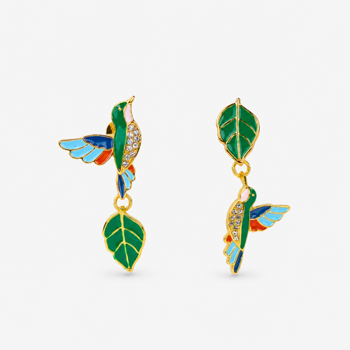 Cherish Hummingbird 18k Garden Dangles featuring colorful enamel hummingbirds and green leaf charms in an asymmetrical design.