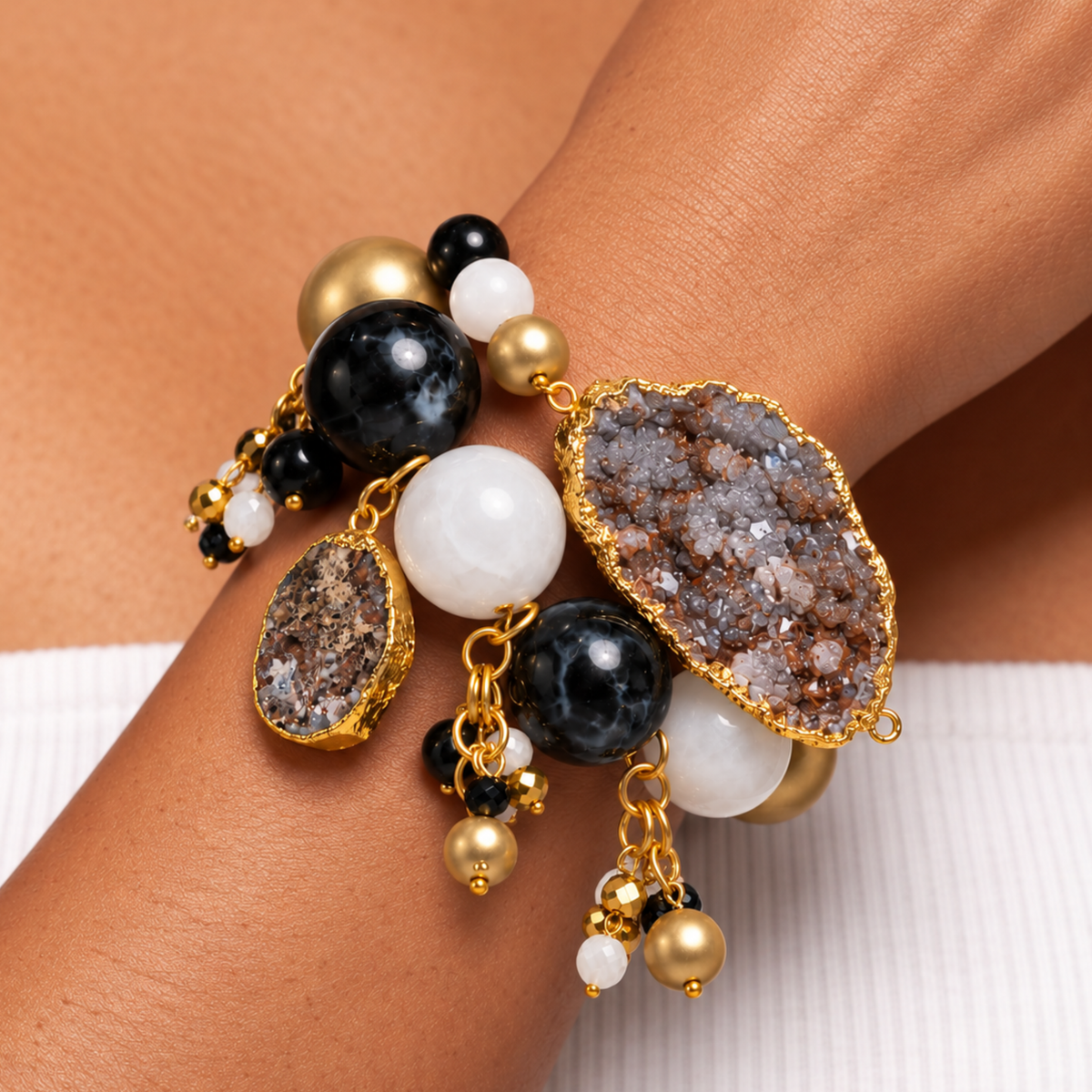 Black and gold statement bracelet featuring chunky round beads, natural agate, and dangling bead clusters.