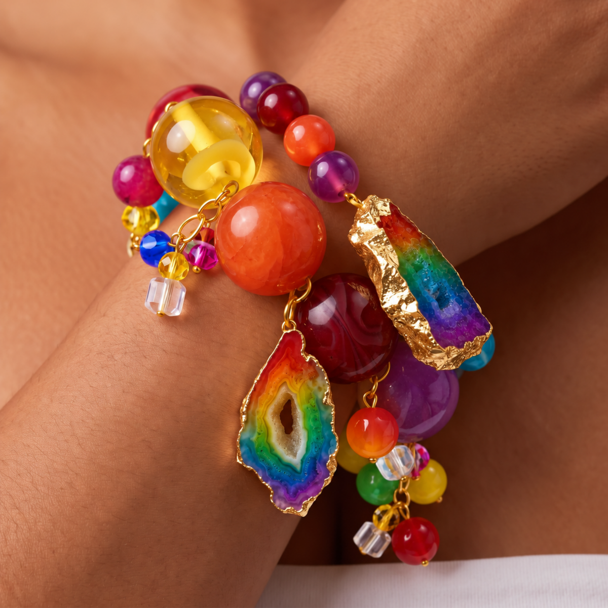 Multicolor bracelet stack featuring red, yellow, orange, purple, and rainbow beads with natural agate accents.