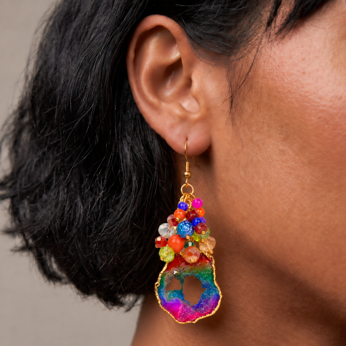 Multicolor statement earrings with raw agate drops, faceted rainbow beads, and gold details.