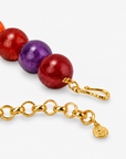 Close-up of Chrysallis Joyride statement necklace with colorful round beads and organic rainbow agate centerpiece.    
Rainbow statement jewelry featuring a raw sliced agate pendant and vibrant jewel toned beads.