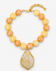 Chrysallis Necklace Lemon Sorbet featuring oversized yellow and peach marbled beads with a natural agate pendant.